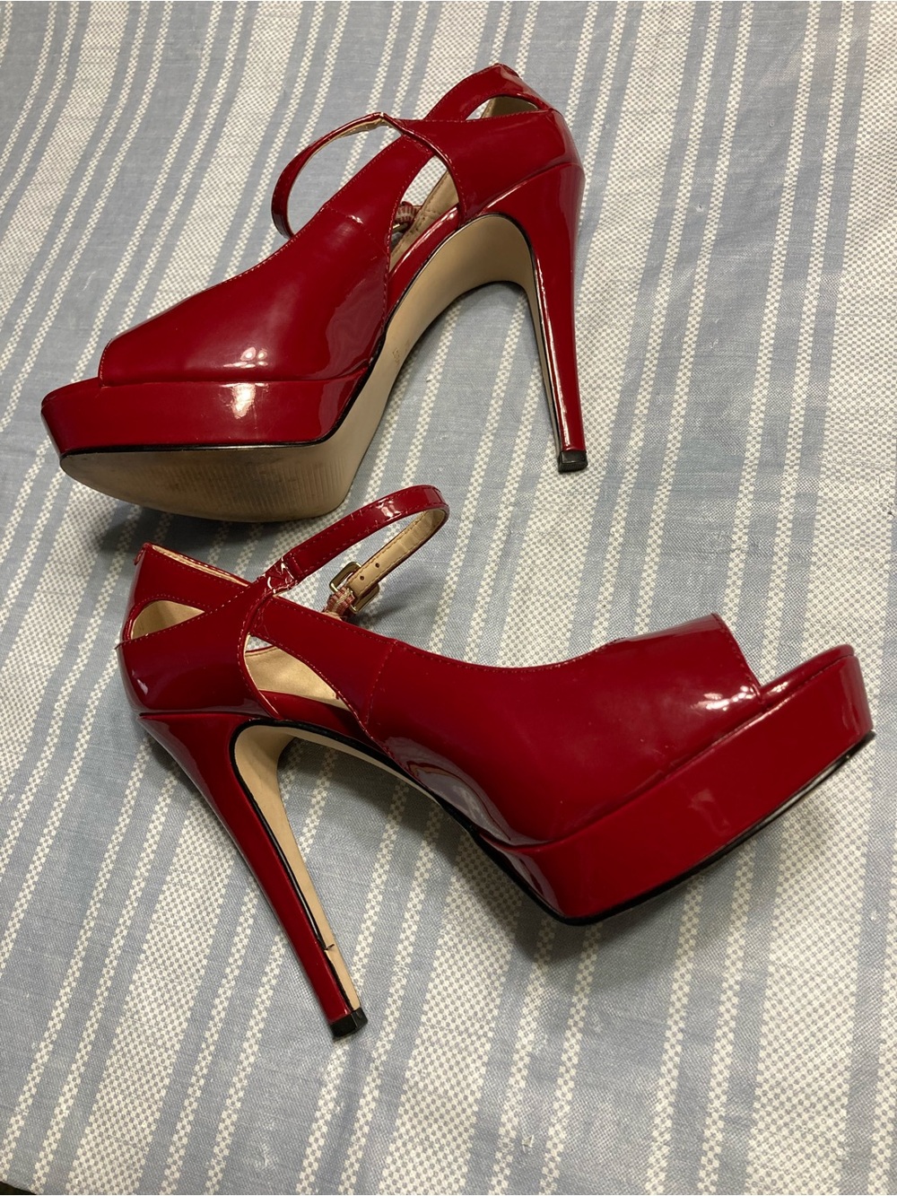 Nine West “WNDONE” deep red, faux patent leather, peep-toe slingback heels.
